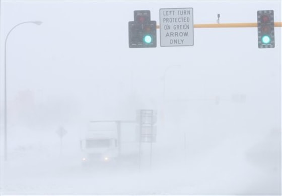 A lone truck makes its way down a road in Grand Forks, N.D., on Monday.